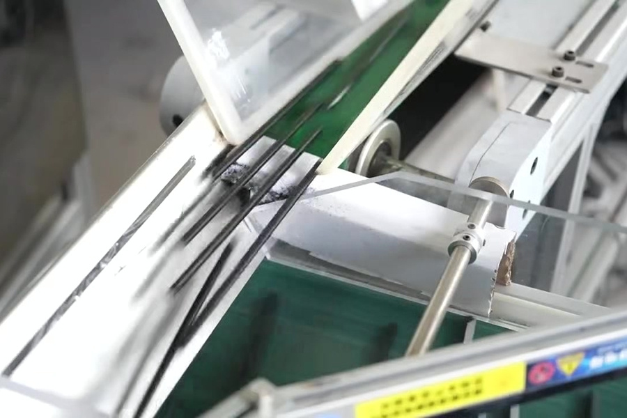 Black straws moving through the cutting line